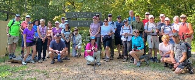 The hikers pause for a rest and photo op on August’s hike at Carters Lake.